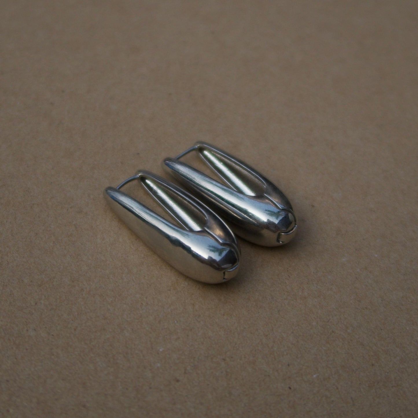 Electric touch silver hoops
